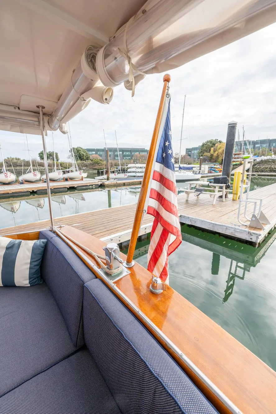 1939 Stephens Brothers Bridgedeck Cruiser with American flag at marina dock.