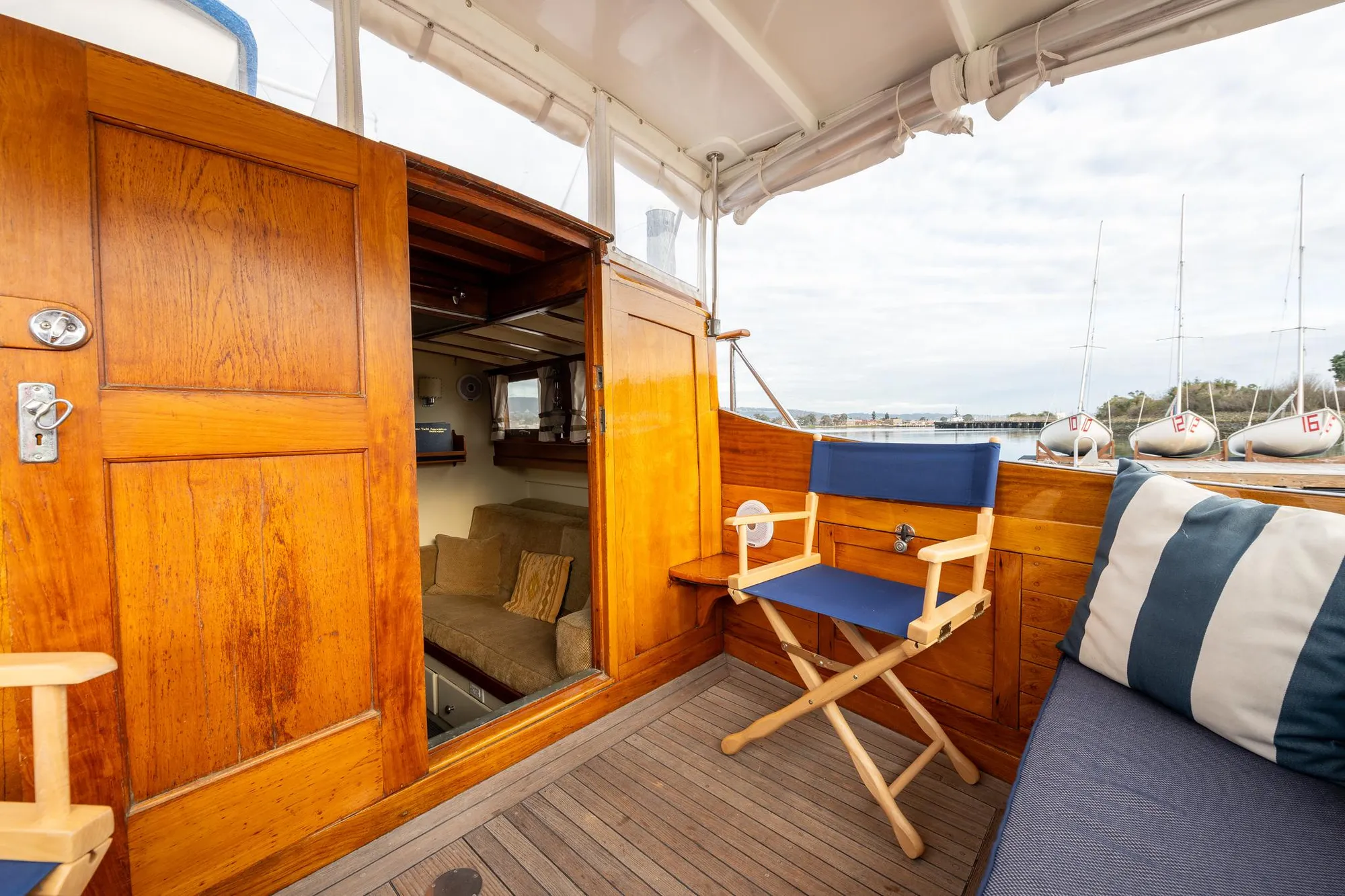 1939 Stephens Brothers Bridgedeck Cruiser interior with wooden paneling and seating.
