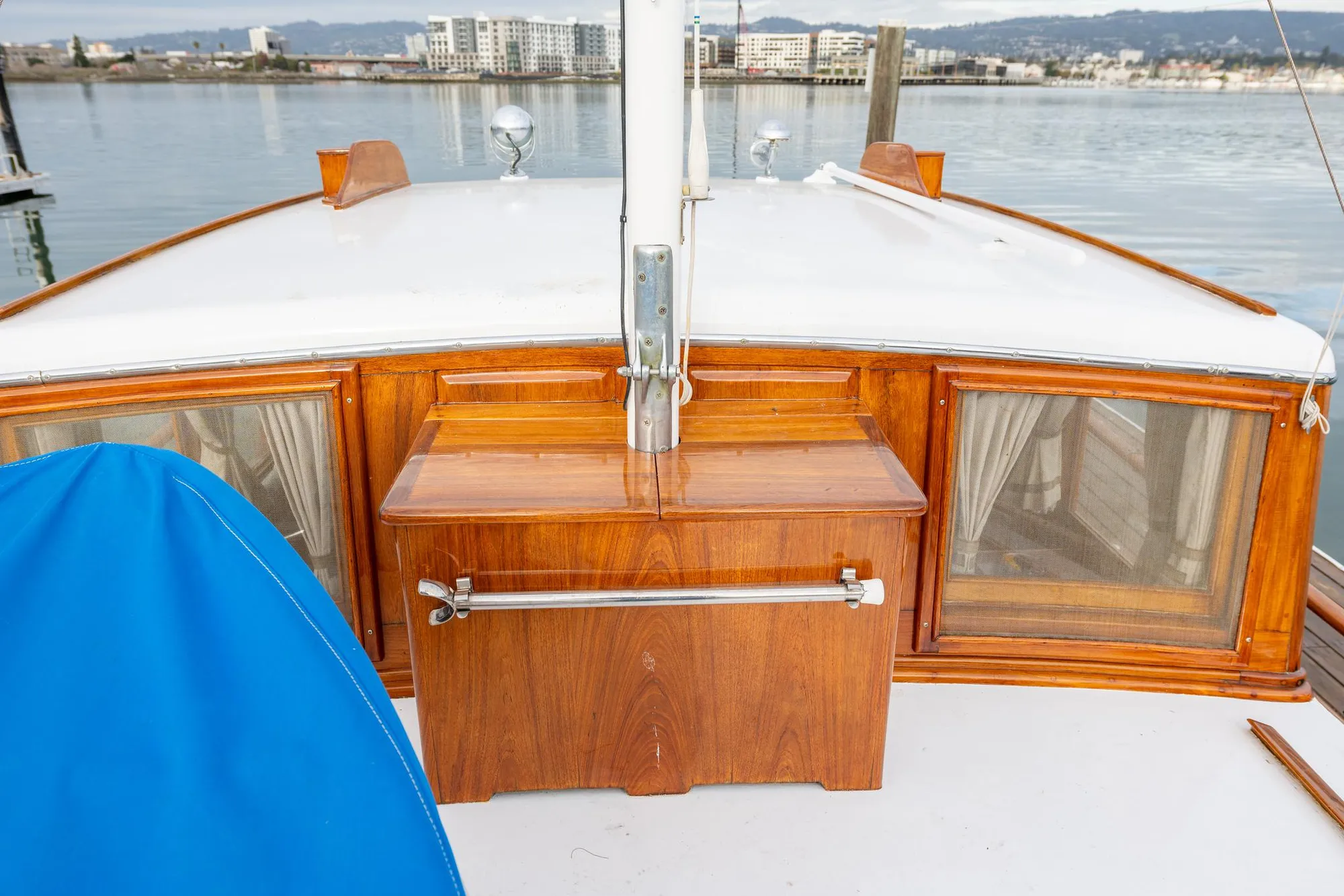 1939 Stephens Brothers Bridgedeck Cruiser with wooden details, docked by the waterfront.