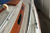 1977 Custom Scalar 28 sailboat deck with wooden finish and safety railing.