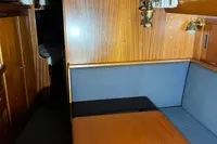 1977 Custom Scalar 28 yacht interior with wood paneling and cozy seating area.