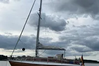 1977 Custom Scalar 28 sailboat on calm water under cloudy skies.