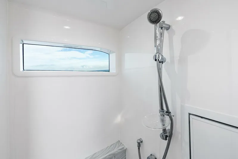  Yacht Photos Pics 2026 Valhalla Boatworks V-46 shower with modern fixtures and ocean view window.