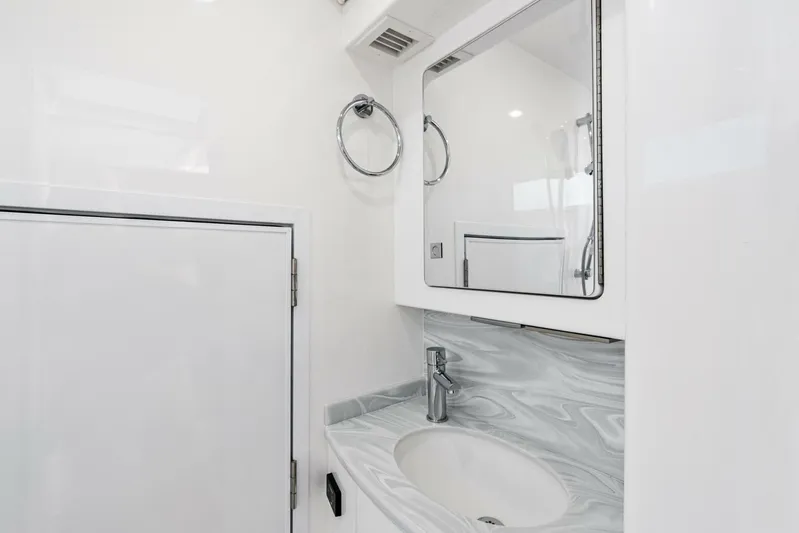  Yacht Photos Pics Luxurious bathroom in 2026 Valhalla Boatworks V-46 with modern sink and mirror.