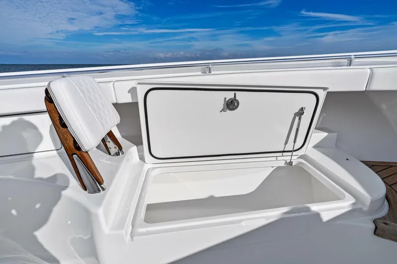  Yacht Photos Pics 2026 Valhalla Boatworks V-46, open storage compartment, white seating, ocean backdrop.