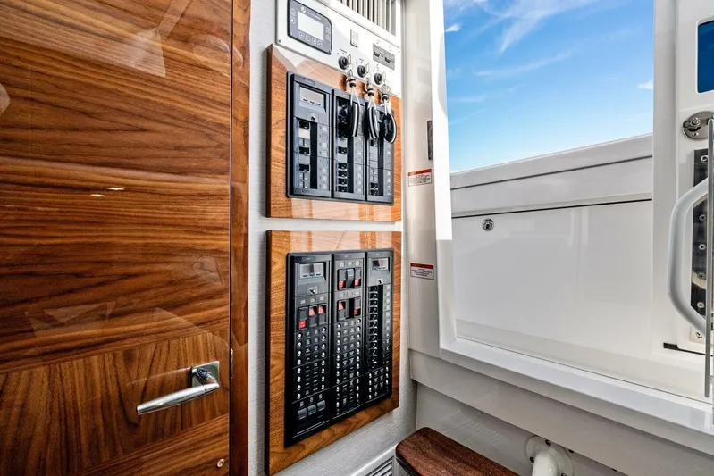  Yacht Photos Pics 2026 Valhalla Boatworks V-46 interior with control panels and wooden finish.