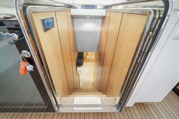  Yacht Photos Pics Interior staircase of 2001 Mangusta 72 Open yacht with wooden paneling and modern design.