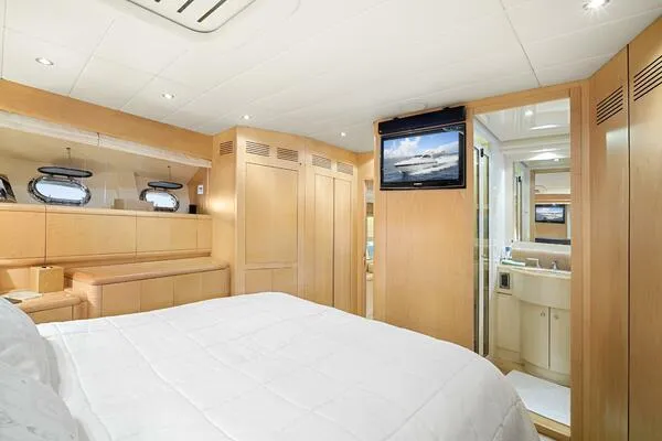  Yacht Photos Pics Luxurious bedroom interior of 2001 Mangusta 72 Open yacht with modern amenities.