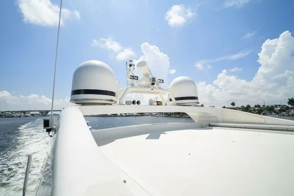  Yacht Photos Pics Mangusta 72 Open yacht, 2001 model, cruising under a clear blue sky.