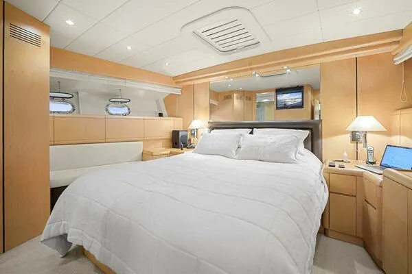  Yacht Photos Pics Luxurious bedroom interior of 2001 Mangusta 72 Open yacht with modern furnishings.
