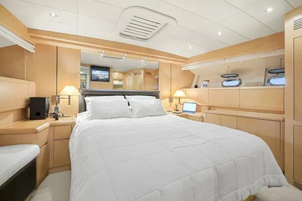  Yacht Photos Pics Luxurious bedroom interior of 2001 Mangusta 72 Open yacht with modern amenities.
