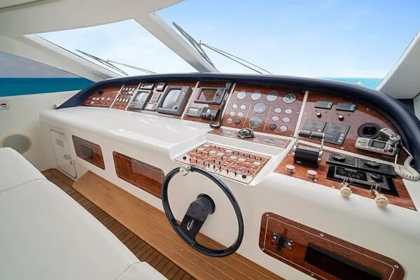  Yacht Photos Pics Cockpit of 2001 Mangusta 72 Open yacht with modern navigation controls and wooden accents.
