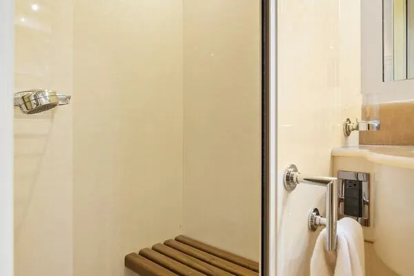  Yacht Photos Pics Shower area in 2001 Mangusta 72 Open yacht with wooden bench.