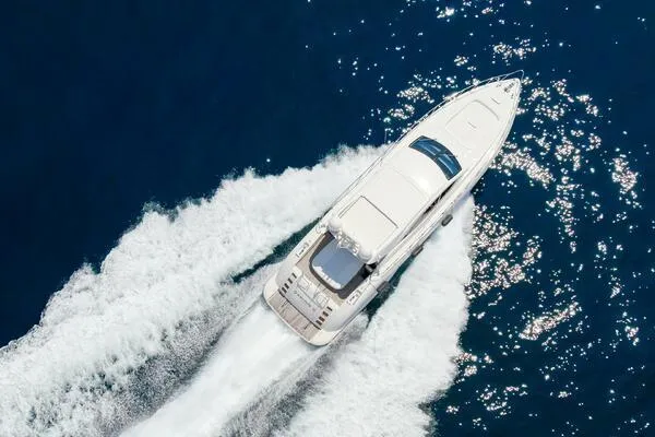  Yacht Photos Pics Mangusta 72 Open 2001 yacht cruising on blue ocean waters, aerial view.