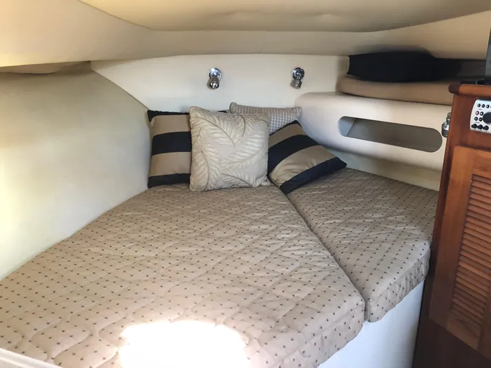  Yacht Photos Pics Cozy cabin interior of 2007 Pursuit 335 Offshore with plush bedding and pillows.