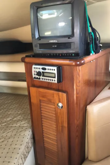  Yacht Photos Pics 2007 Pursuit 335 Offshore cabin with vintage TV and wooden cabinet.