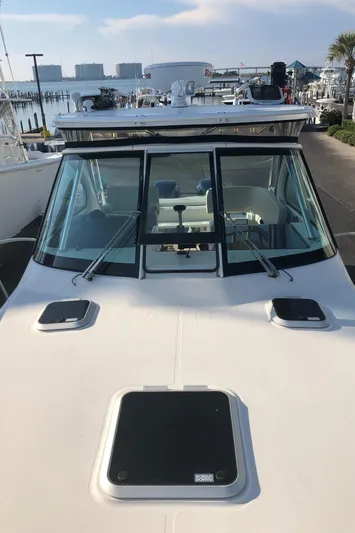  Yacht Photos Pics 2007 Pursuit 335 Offshore boat docked, showcasing windshield and deck features.