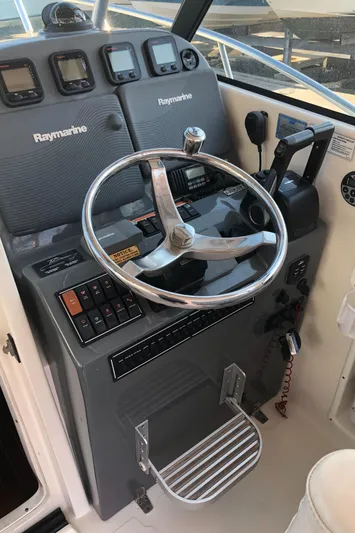  Yacht Photos Pics 2007 Pursuit 335 Offshore helm with Raymarine electronics and stainless steel steering wheel.