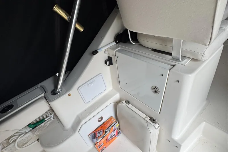  Yacht Photos Pics 2007 Pursuit OS 335 Offshore boat interior with storage compartments and seating.