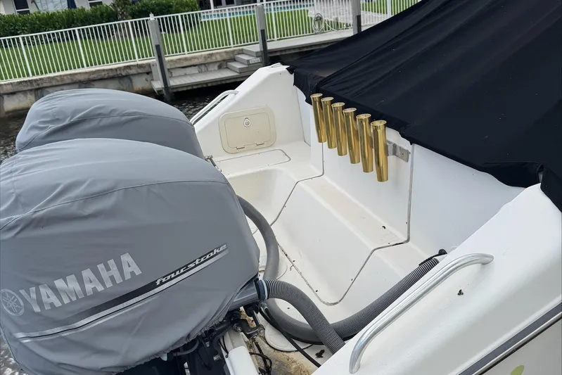  Yacht Photos Pics 2007 Pursuit OS 335 Offshore boat with Yamaha engines and rod holders, docked by a railing.