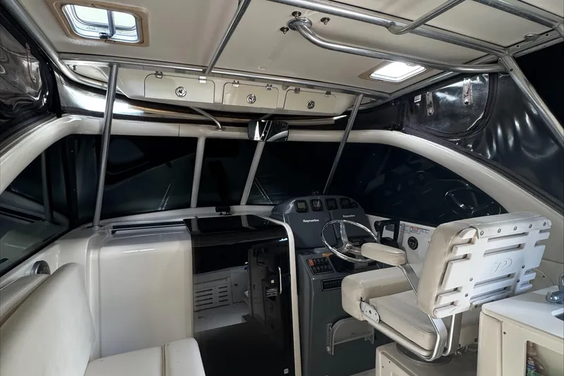  Yacht Photos Pics 2007 Pursuit OS 335 Offshore boat interior with helm, steering wheel, and seating.