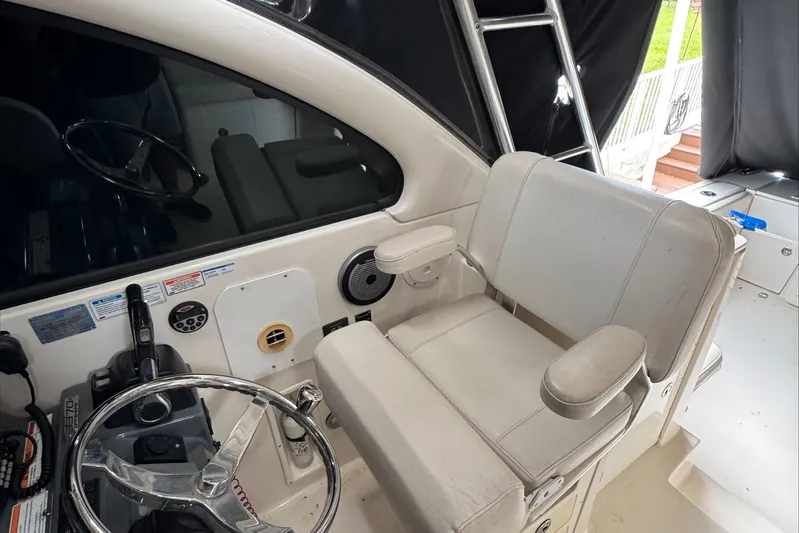  Yacht Photos Pics 2007 Pursuit OS 335 Offshore helm with steering wheel and captain's chair.