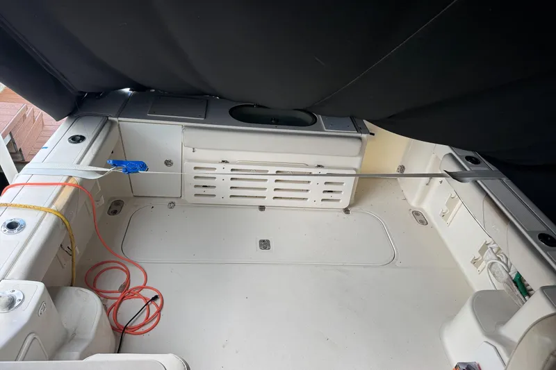  Yacht Photos Pics 2007 Pursuit OS 335 Offshore boat interior with storage compartments and fishing equipment.