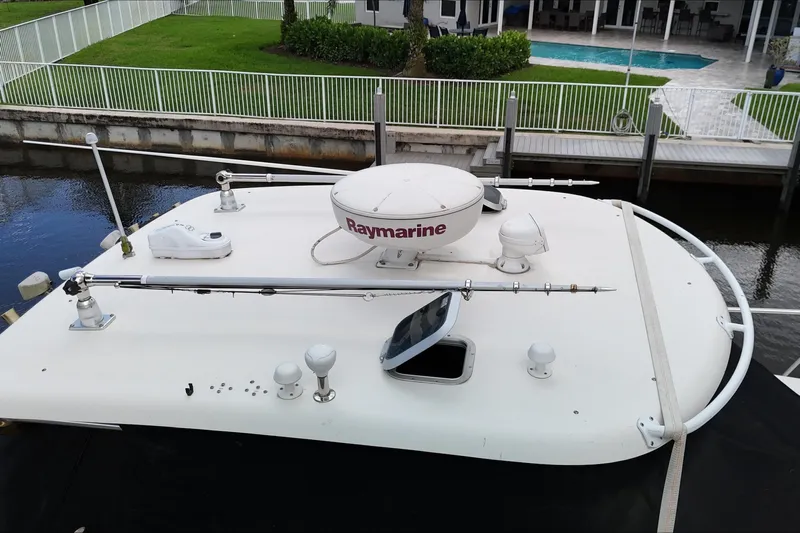  Yacht Photos Pics 2007 Pursuit OS 335 Offshore boat with Raymarine radar, docked near a poolside area.