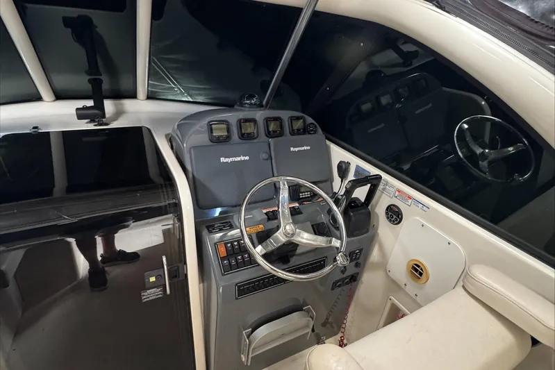  Yacht Photos Pics 2007 Pursuit OS 335 Offshore boat cockpit with steering wheel and navigation controls.