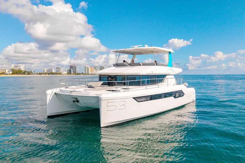 Freedom Yacht Photos Pics 2022 Leopard 53 Powercat yacht cruising on clear blue waters under a sunny sky.