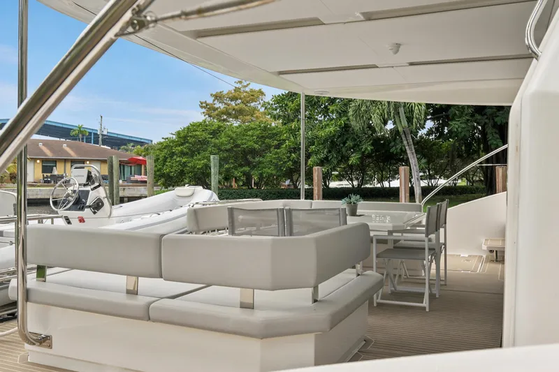 Freedom Yacht Photos Pics Luxurious 2022 Leopard 53 Powercat yacht with elegant outdoor seating and dining area.