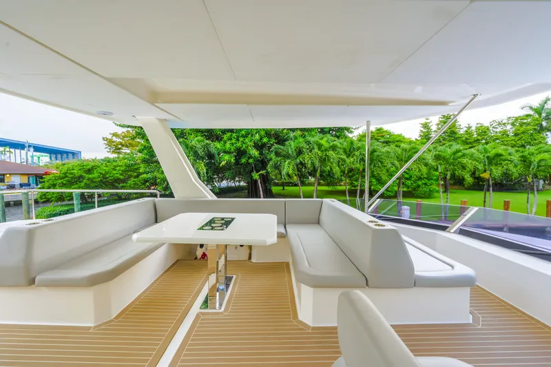 Freedom Yacht Photos Pics Luxurious 2022 Leopard 53 Powercat yacht with spacious outdoor seating and table.