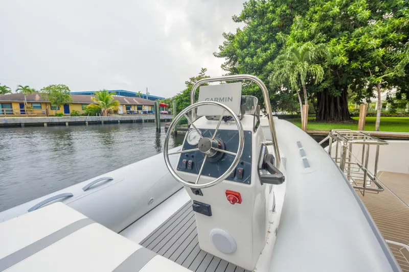 Freedom Yacht Photos Pics 2022 Leopard 53 Powercat helm with Garmin system, docked by a scenic waterfront.