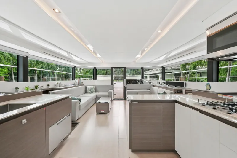 Freedom Yacht Photos Pics Luxurious interior of 2022 Leopard 53 Powercat yacht with modern kitchen and seating area.