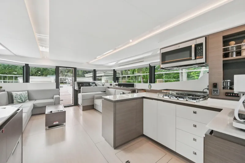 Freedom Yacht Photos Pics Luxurious interior of 2022 Leopard 53 Powercat yacht with modern kitchen and seating area.