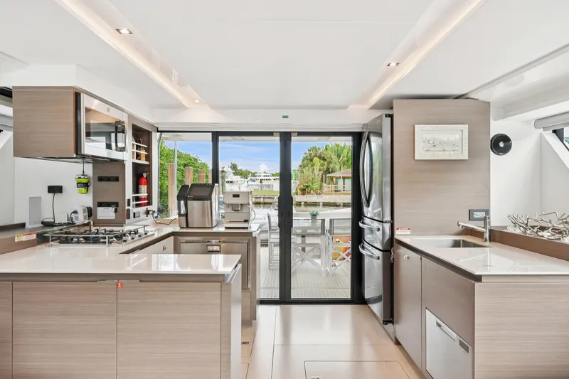 Freedom Yacht Photos Pics Modern kitchen interior on 2022 Leopard 53 Powercat yacht, featuring sleek design and outdoor view.