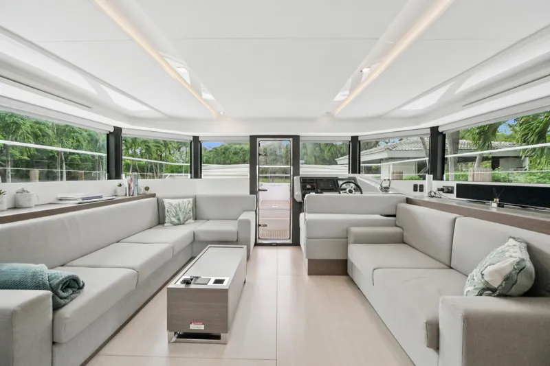 Freedom Yacht Photos Pics Luxurious interior of 2022 Leopard 53 Powercat yacht with modern seating and panoramic windows.