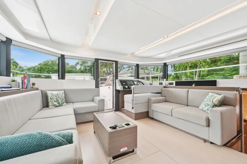 Freedom Yacht Photos Pics Luxurious interior of 2022 Leopard 53 Powercat yacht with modern seating and panoramic windows.