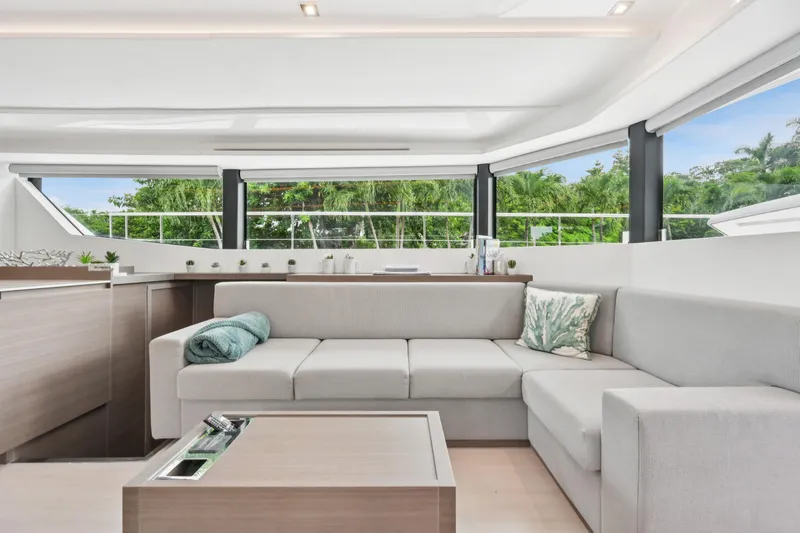 Freedom Yacht Photos Pics Luxurious interior of 2022 Leopard 53 Powercat yacht with modern seating and panoramic windows.