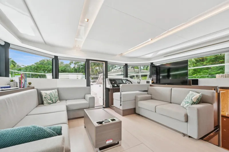 Freedom Yacht Photos Pics Luxurious interior of 2022 Leopard 53 Powercat yacht with modern seating and large windows.