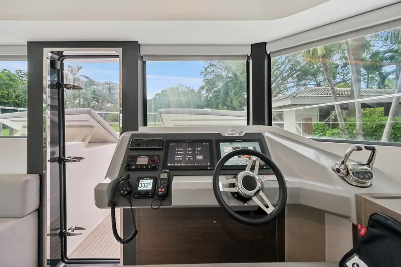 Freedom Yacht Photos Pics Interior helm of 2022 Leopard 53 Powercat with modern navigation equipment and panoramic windows.