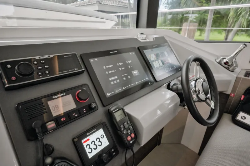 Freedom Yacht Photos Pics Control panel of 2022 Leopard 53 Powercat with advanced navigation systems and steering wheel.