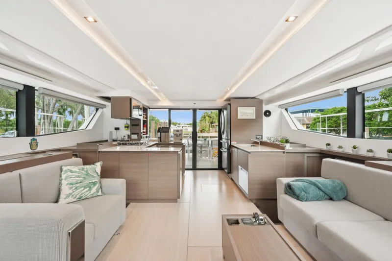 Freedom Yacht Photos Pics Luxurious interior of 2022 Leopard 53 Powercat yacht with modern furnishings and panoramic windows.