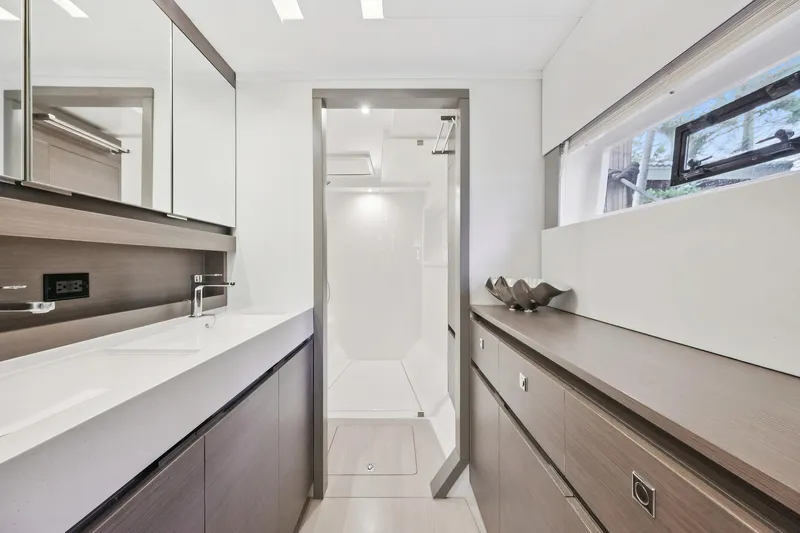 Freedom Yacht Photos Pics Modern bathroom interior on 2022 Leopard 53 Powercat yacht, featuring sleek design and ample storage.