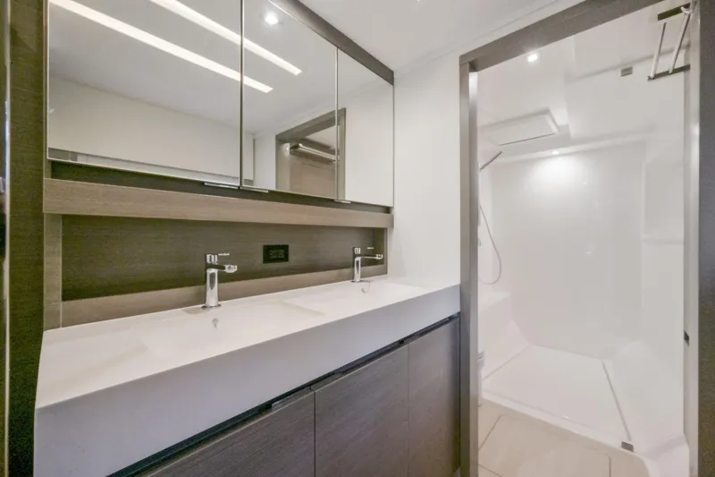 Freedom Yacht Photos Pics Modern bathroom on 2022 Leopard 53 Powercat yacht with dual sinks and spacious shower.