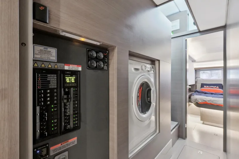 Freedom Yacht Photos Pics Interior of 2022 Leopard 53 Powercat featuring control panel, washer, and cozy bedroom.