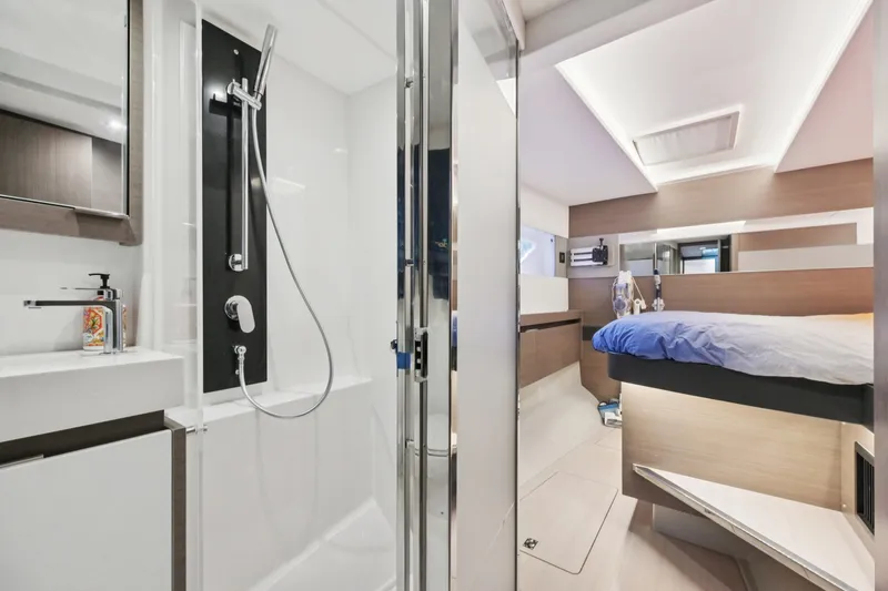 Freedom Yacht Photos Pics Luxurious interior of 2022 Leopard 53 Powercat featuring modern bathroom and cozy bedroom.