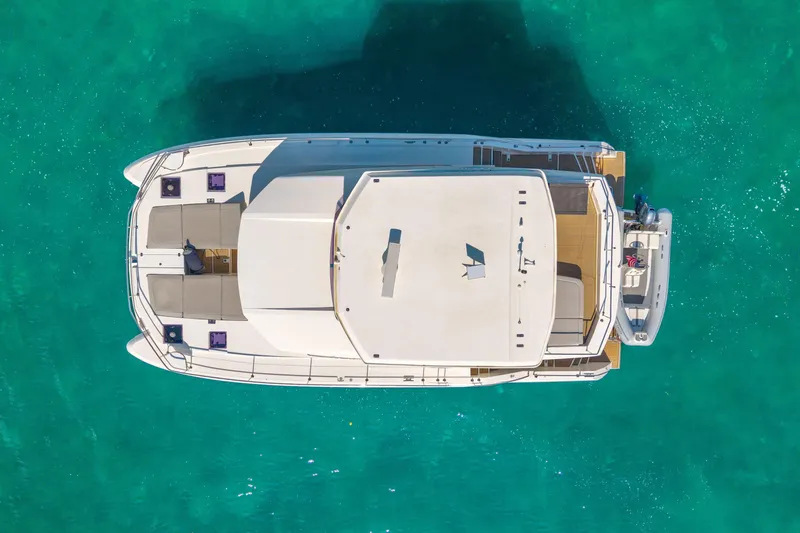 Freedom Yacht Photos Pics Aerial view of 2022 Leopard 53 Powercat yacht on turquoise water.