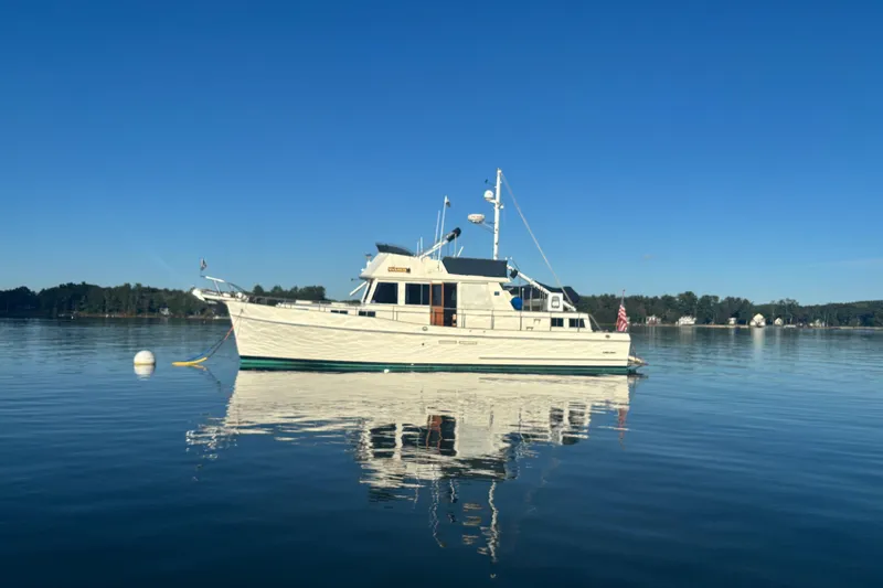 Maximon Yacht Photos Pics 1989 Grand Banks 46 yacht on calm water under clear blue sky.