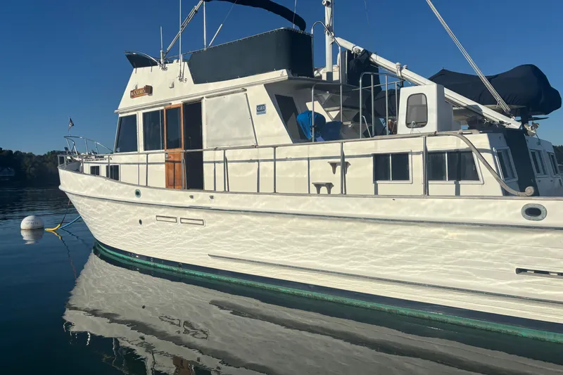 Maximon Yacht Photos Pics 1989 Grand Banks 46 yacht moored on calm water under clear blue sky.